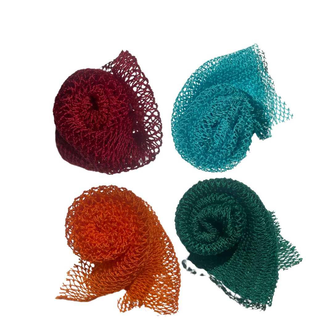 Four colourful African net sponges (loofahs/scrubbies) in red, blue, orange, and green on a white background. Imported from Ghana. Sold in Canada by Kerl Beauty.